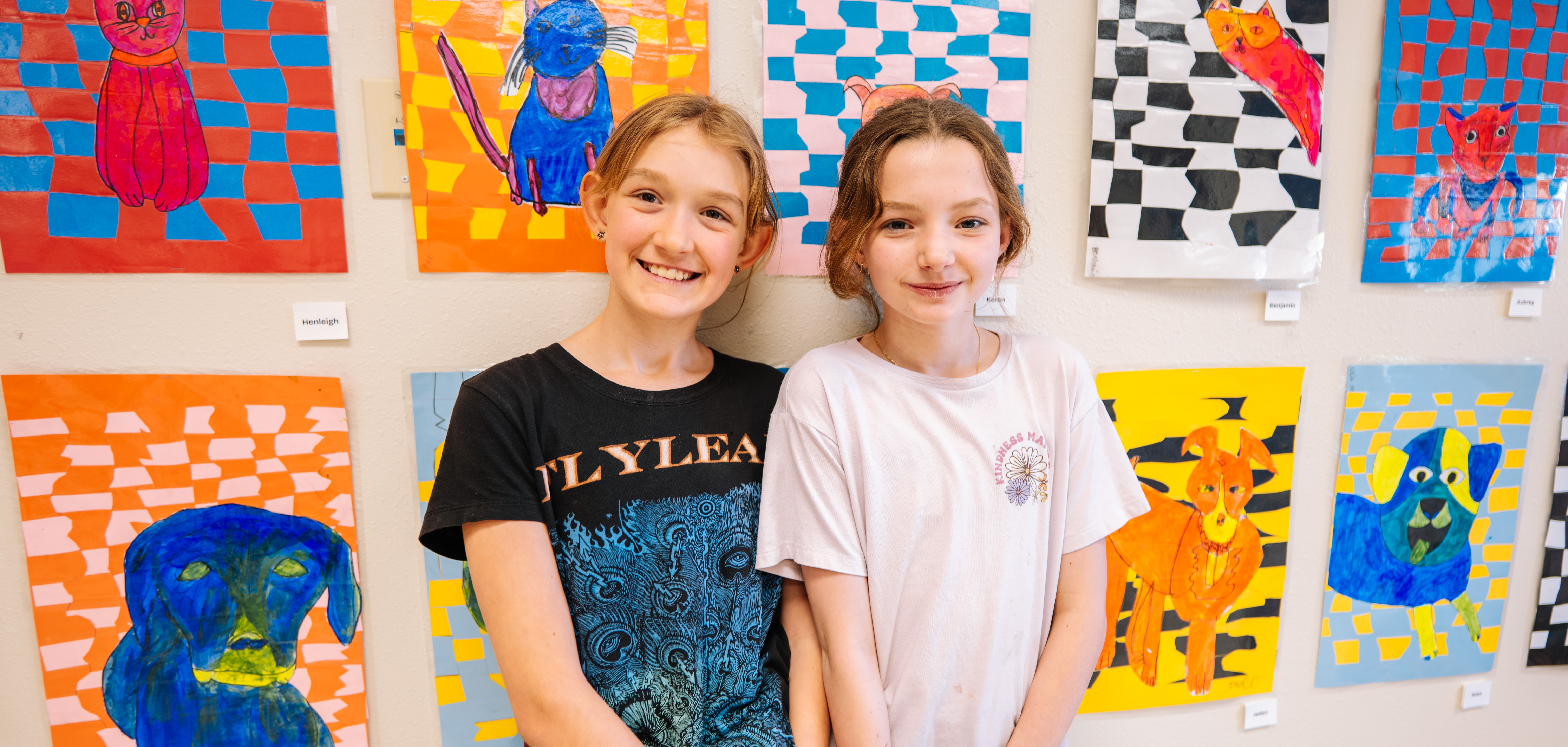 Two student smiling with art background