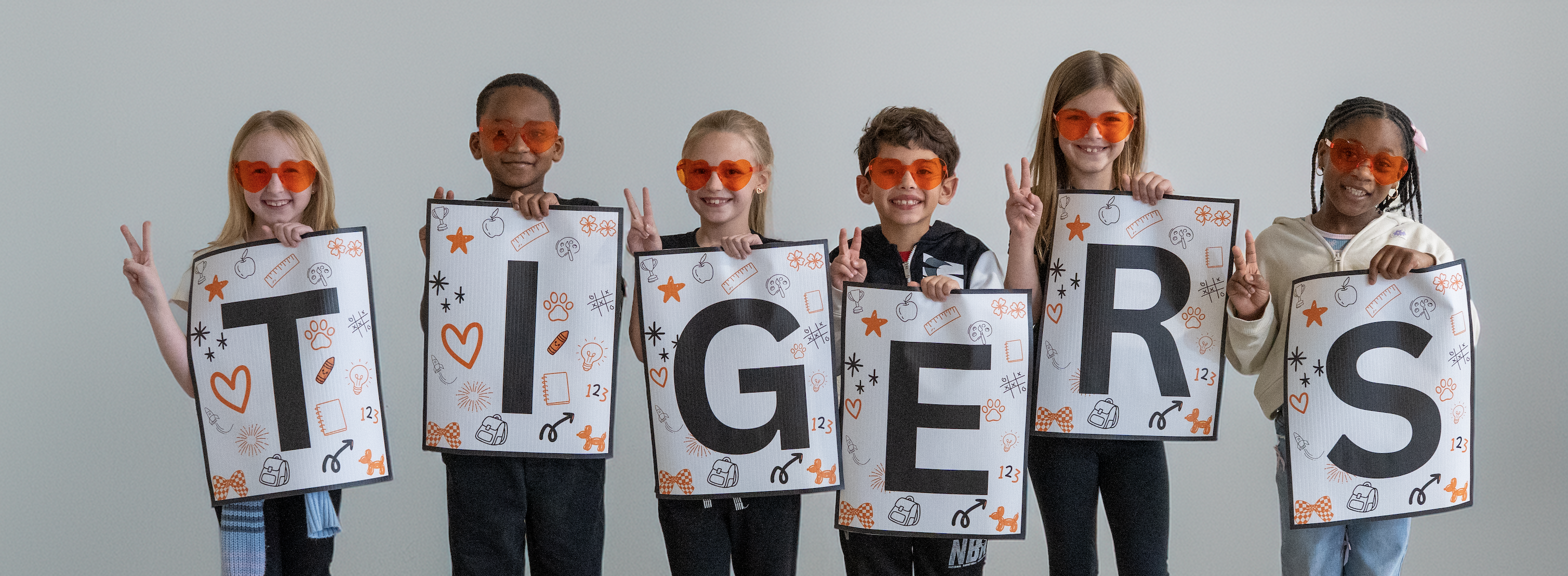 Freedom students spelling out the word Tigers 