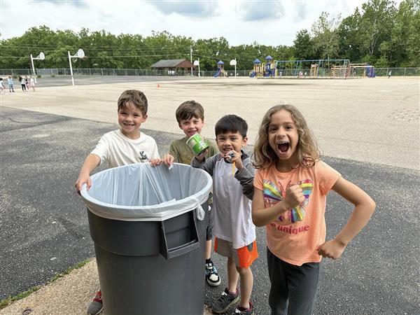 kids throwing the garbage in the trash can