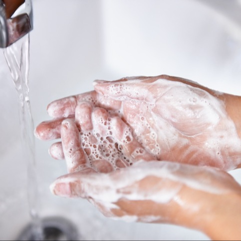 hands being washed with soap
