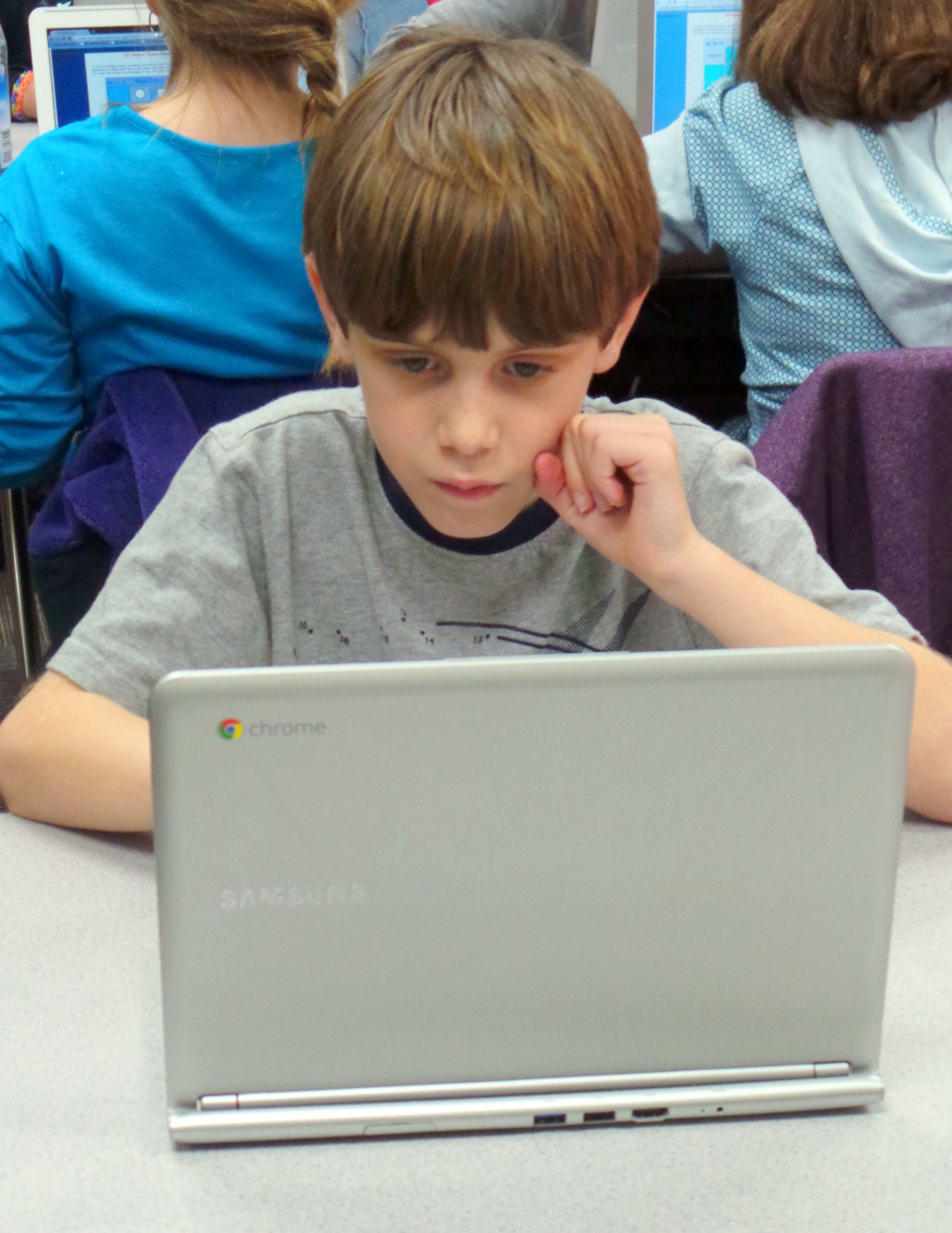 kid with a laptop checking something
