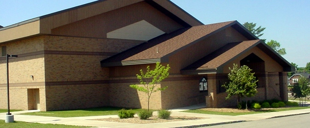 image of a brown building with trees in front
