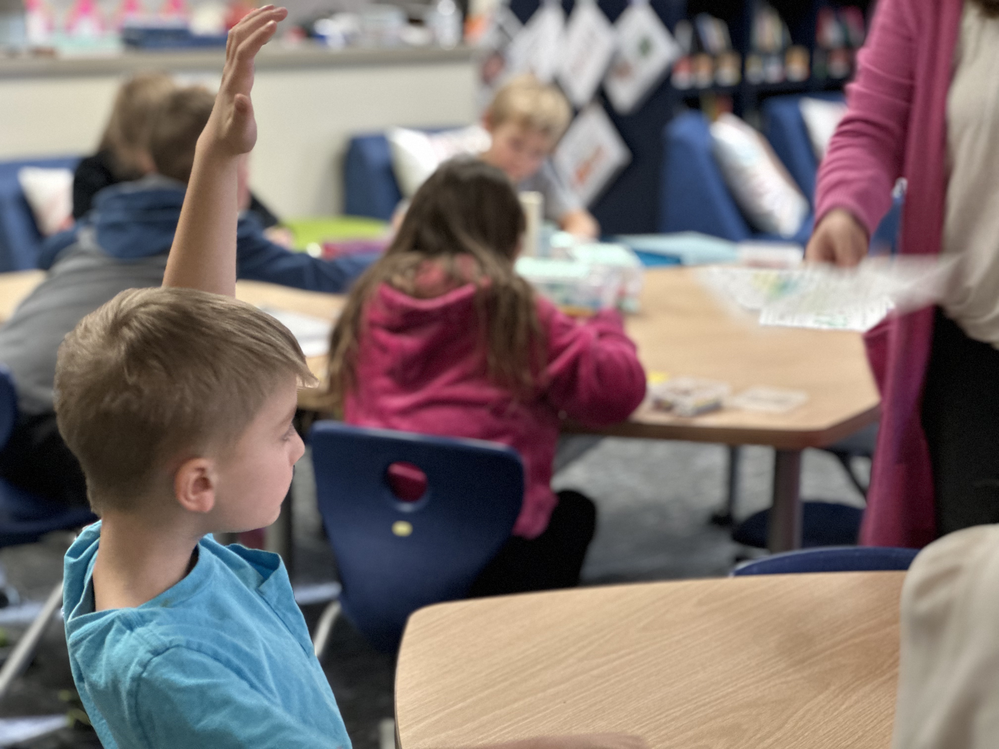 student raising hand in class