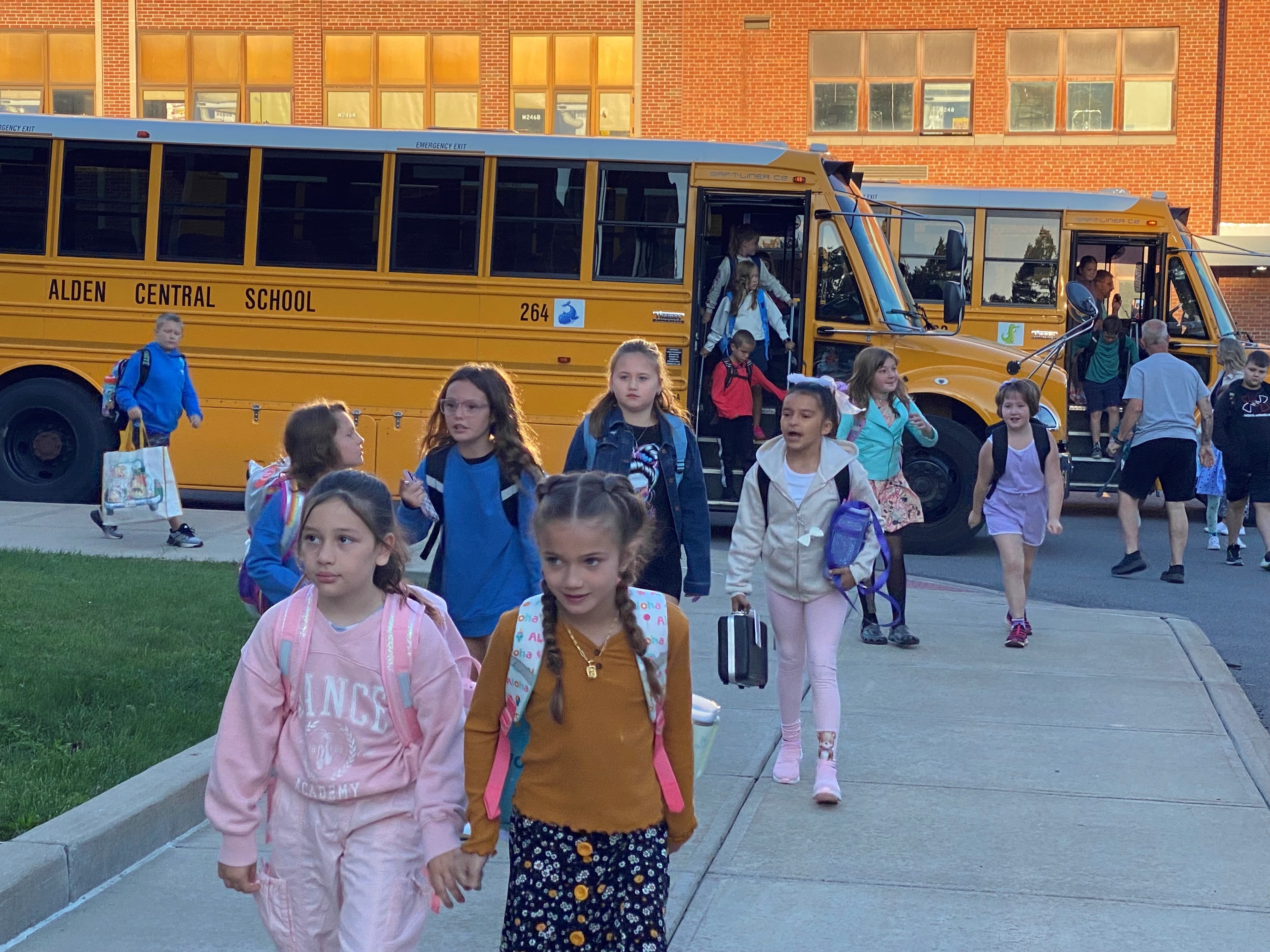 students in bus line.