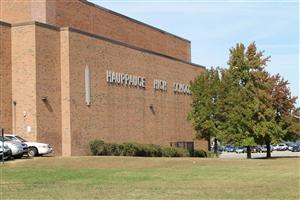 Photo of front of High School with the name displayed on the wall.