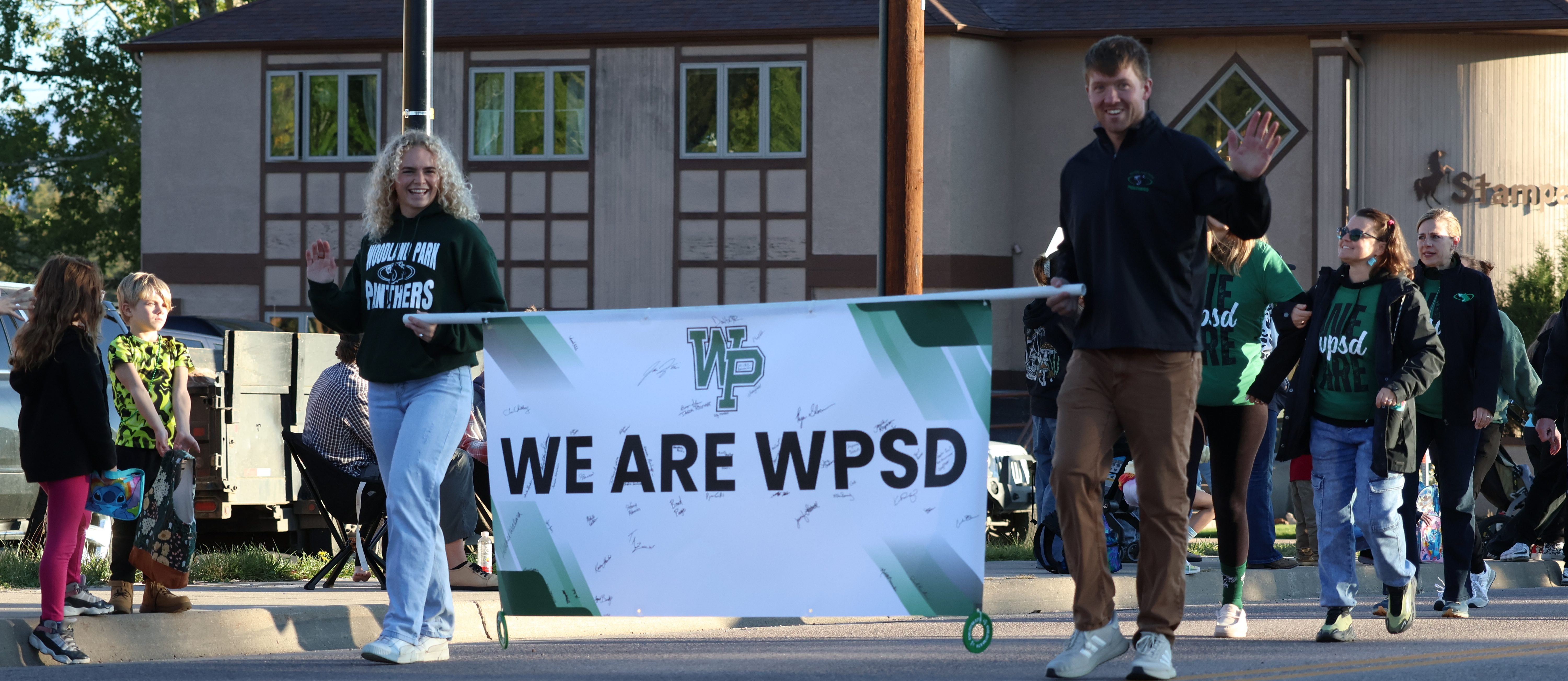 Staff walk with We Are WPSD banner in the homecoming parade