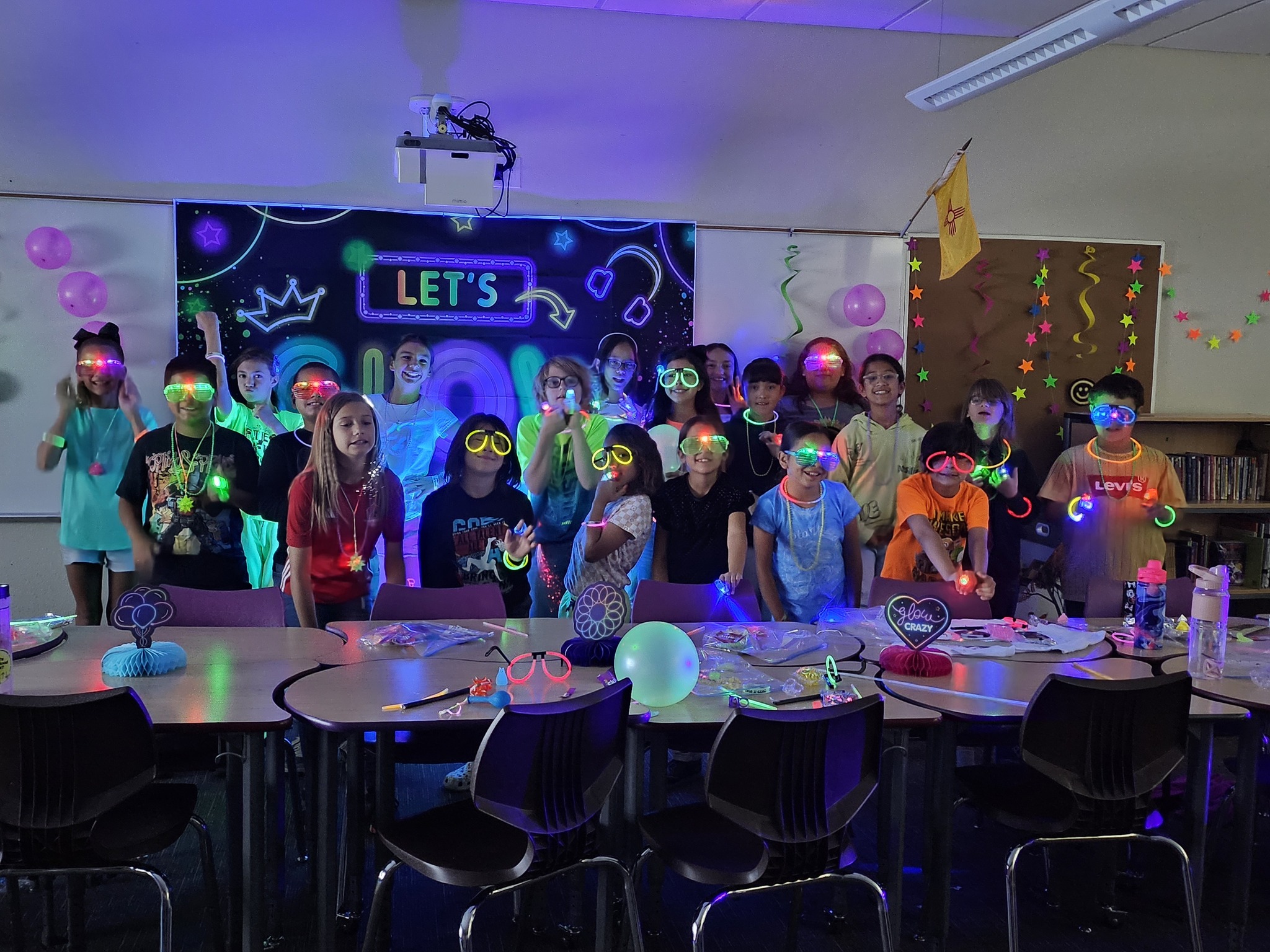 Students celebrating the last days of school with glow stick and glasses
