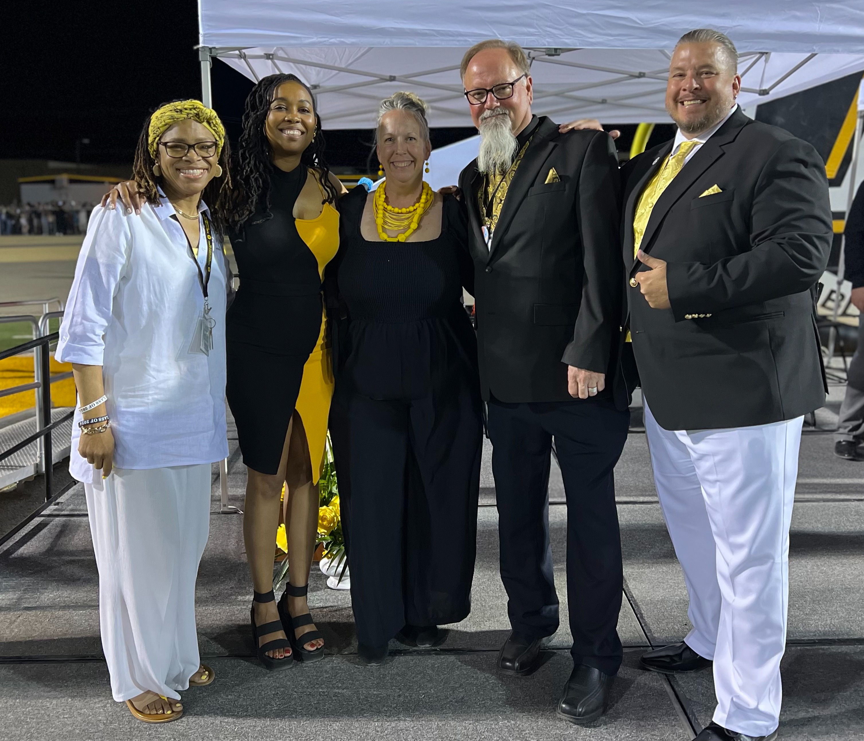 Principal and asst. principals dressed in black, gold and white at the AHS 2024 graduation