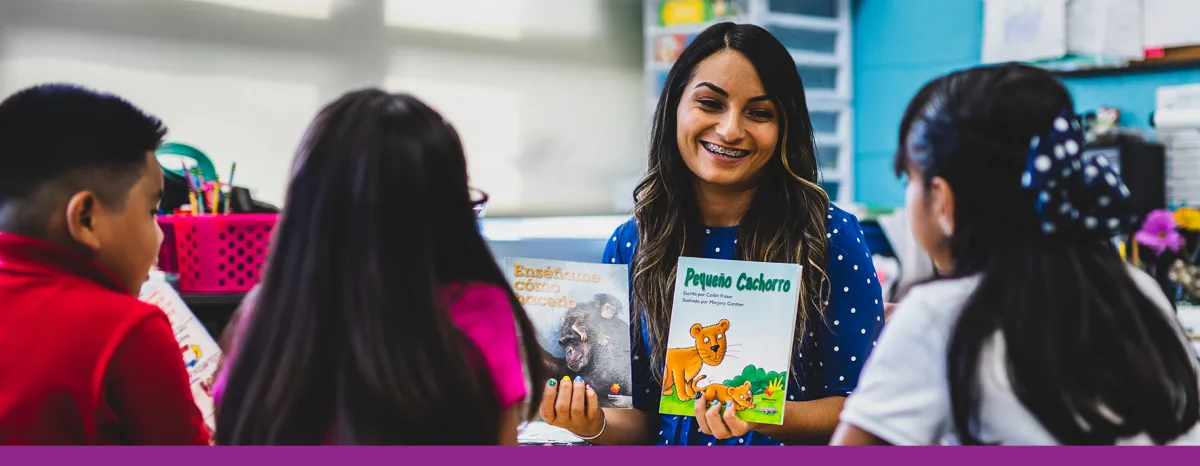 Teacher with two books explaining to kids