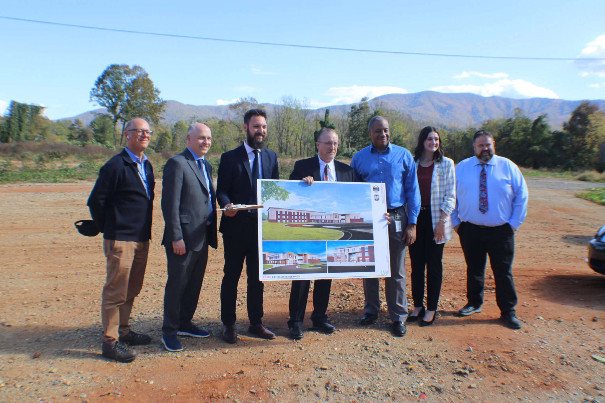 Mark Dessauer, Geoff Coltrane, Ryan McMahan, Superintendent Mark Sale, State Superintendent Mo Green, Lydia Sale, and Dr. Brandon Sutton at the construction site for the new Swain Middle School