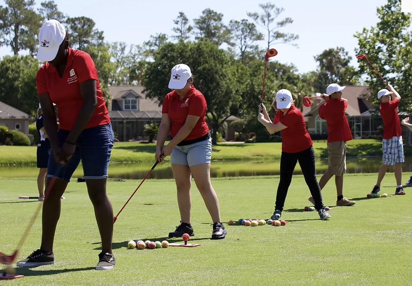 students playing golf