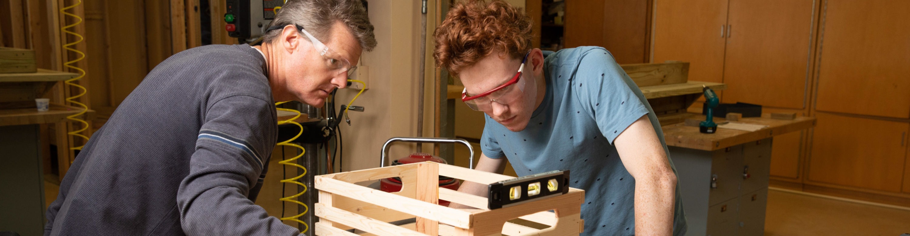 Student and teacher making a wooden box