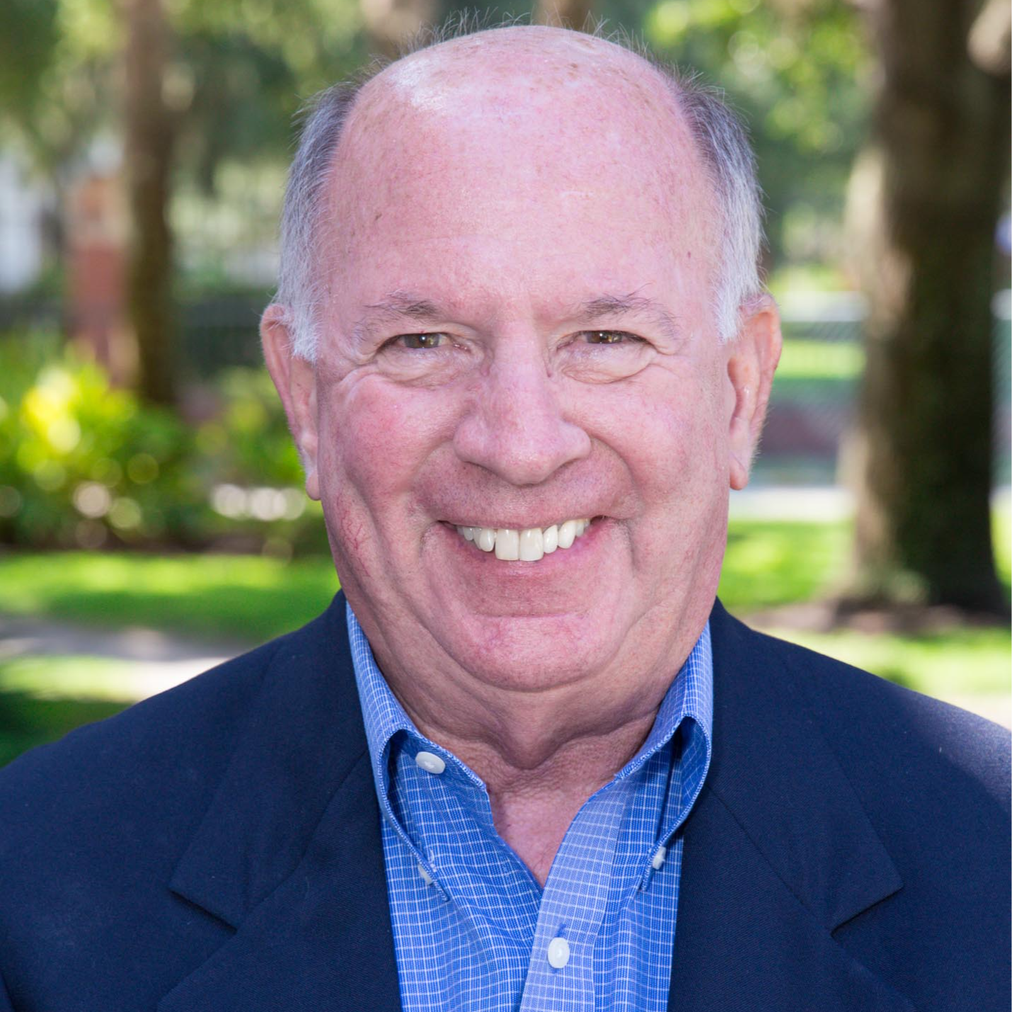 Dr. Zavelson wearing a blue checkered shirt and navy blue blazer.