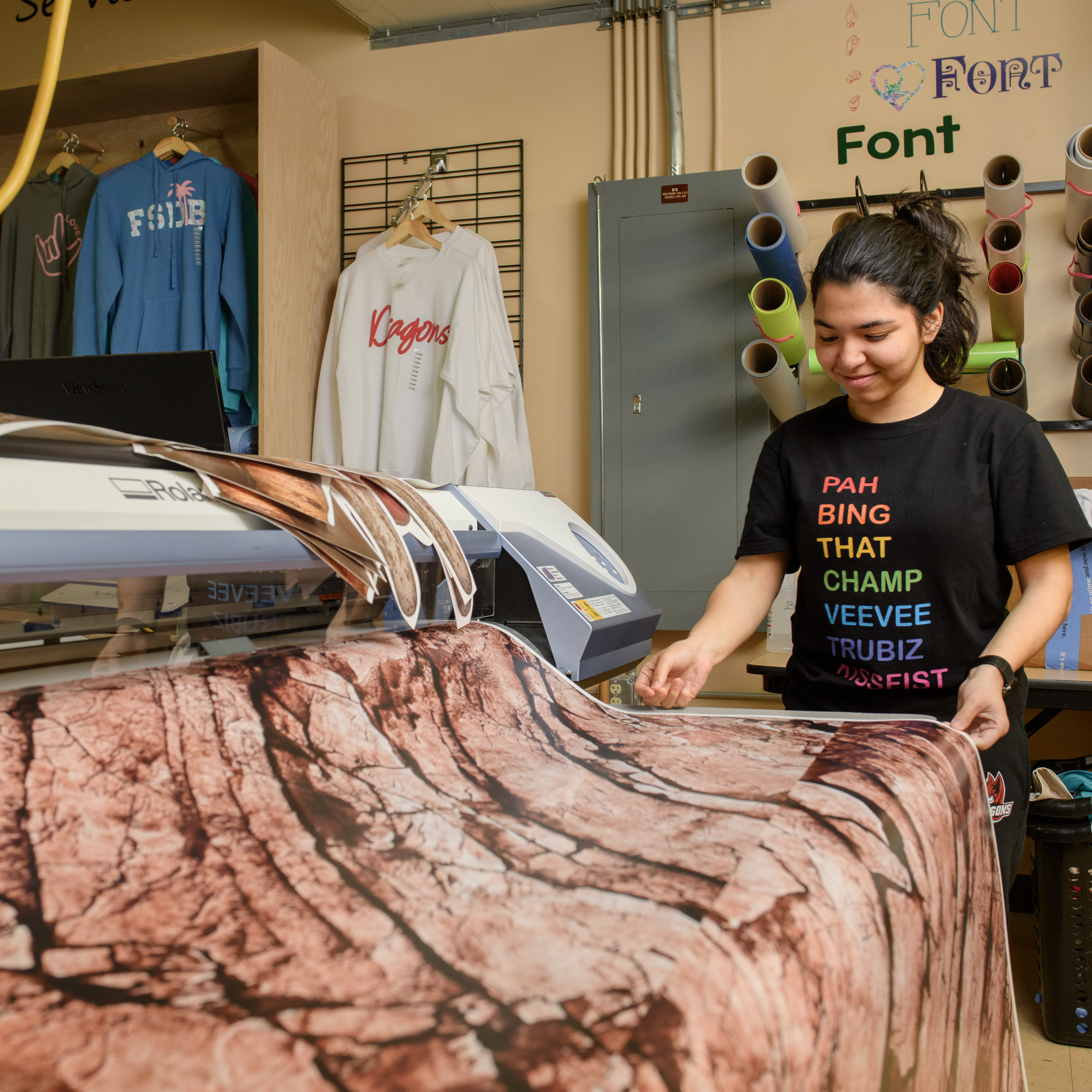 Deaf girl using a large format printer.