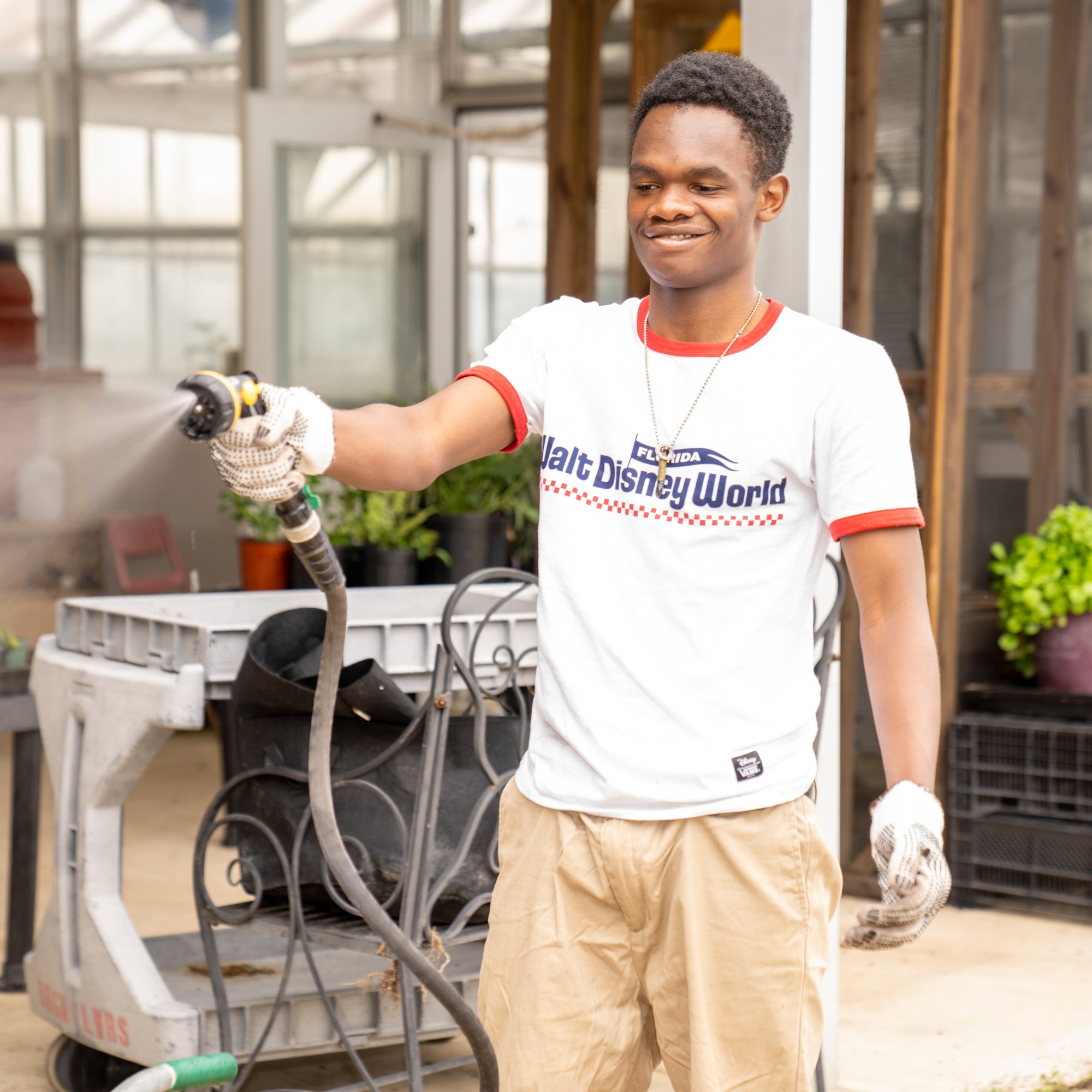 Student using hose in Garden Center