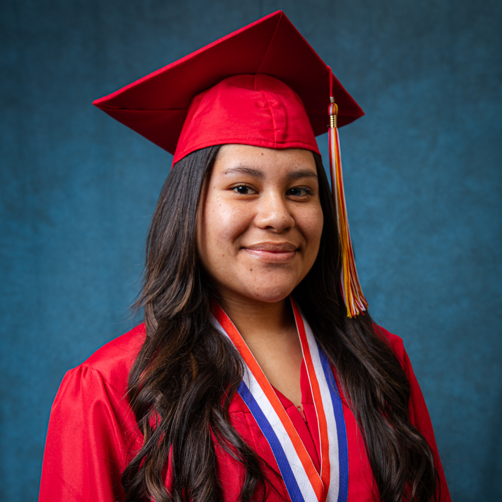 Guadalupe Bazaldua wearing a red cap and gown.