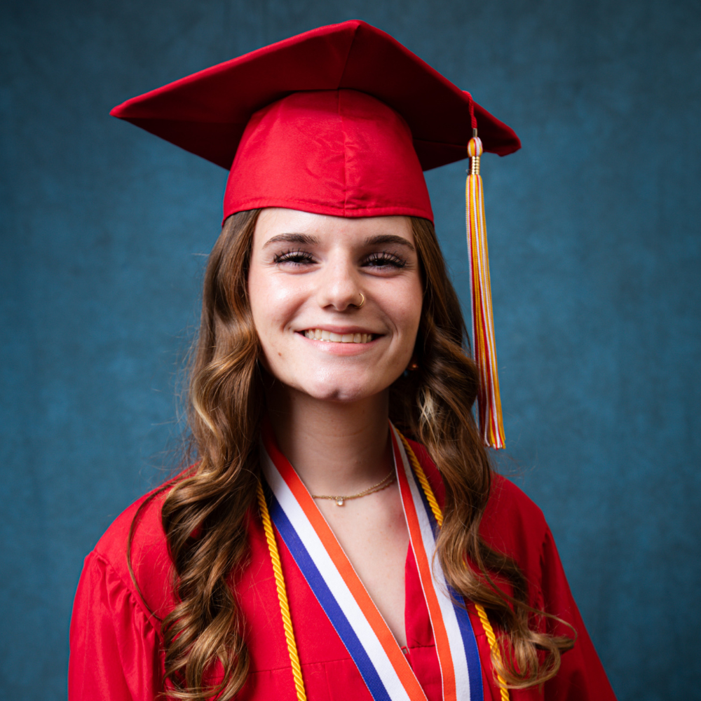 Ivabella Essex wearing a blue cap and gown.