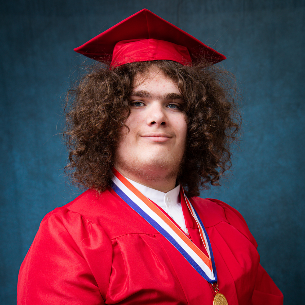 Shane Ferenc wearing a red cap and gown.