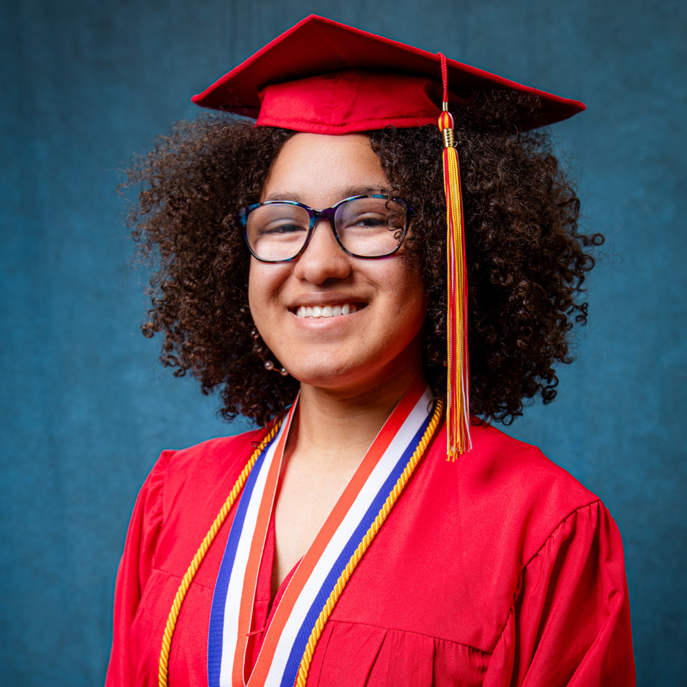 Kyra Hollerman wearing a red cap and gown.