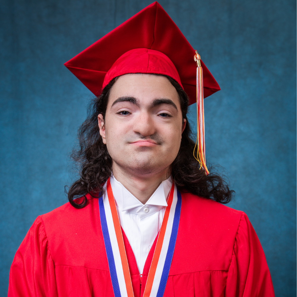 Dracob Hunt wearing a red cap and gown.