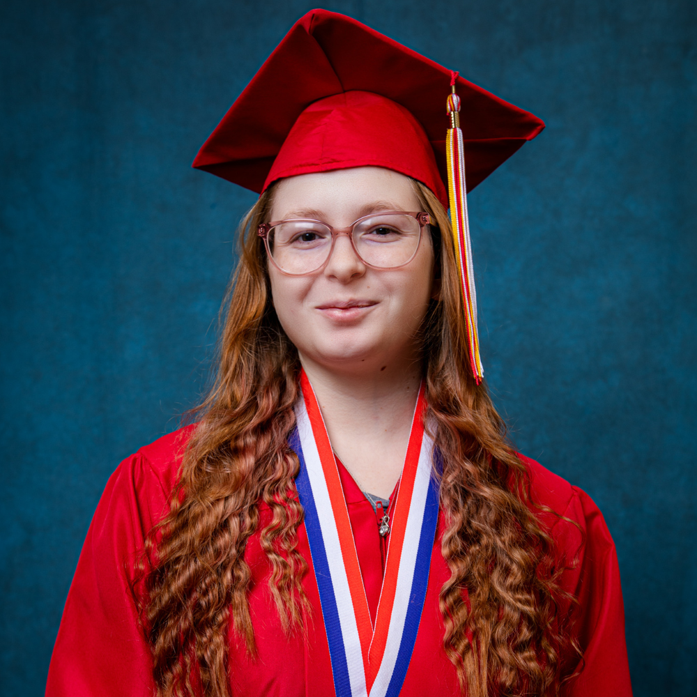 Ashlyn Jackson wearing a red cap and gown.