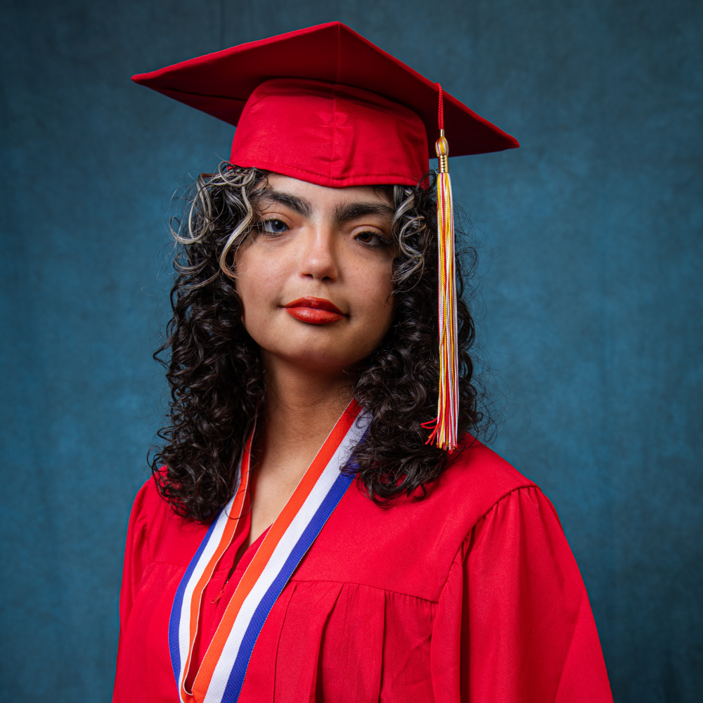 Jaylene Rivera wearing a red cap and gown.