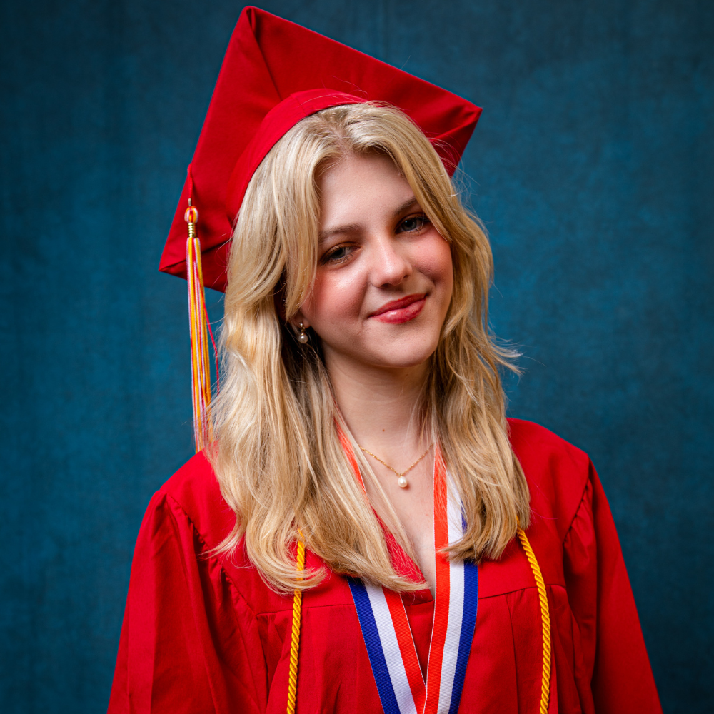 Vanessa LoSauro wearing a red cap and gown.