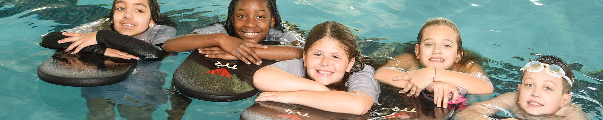 Five students swimming in the pool.