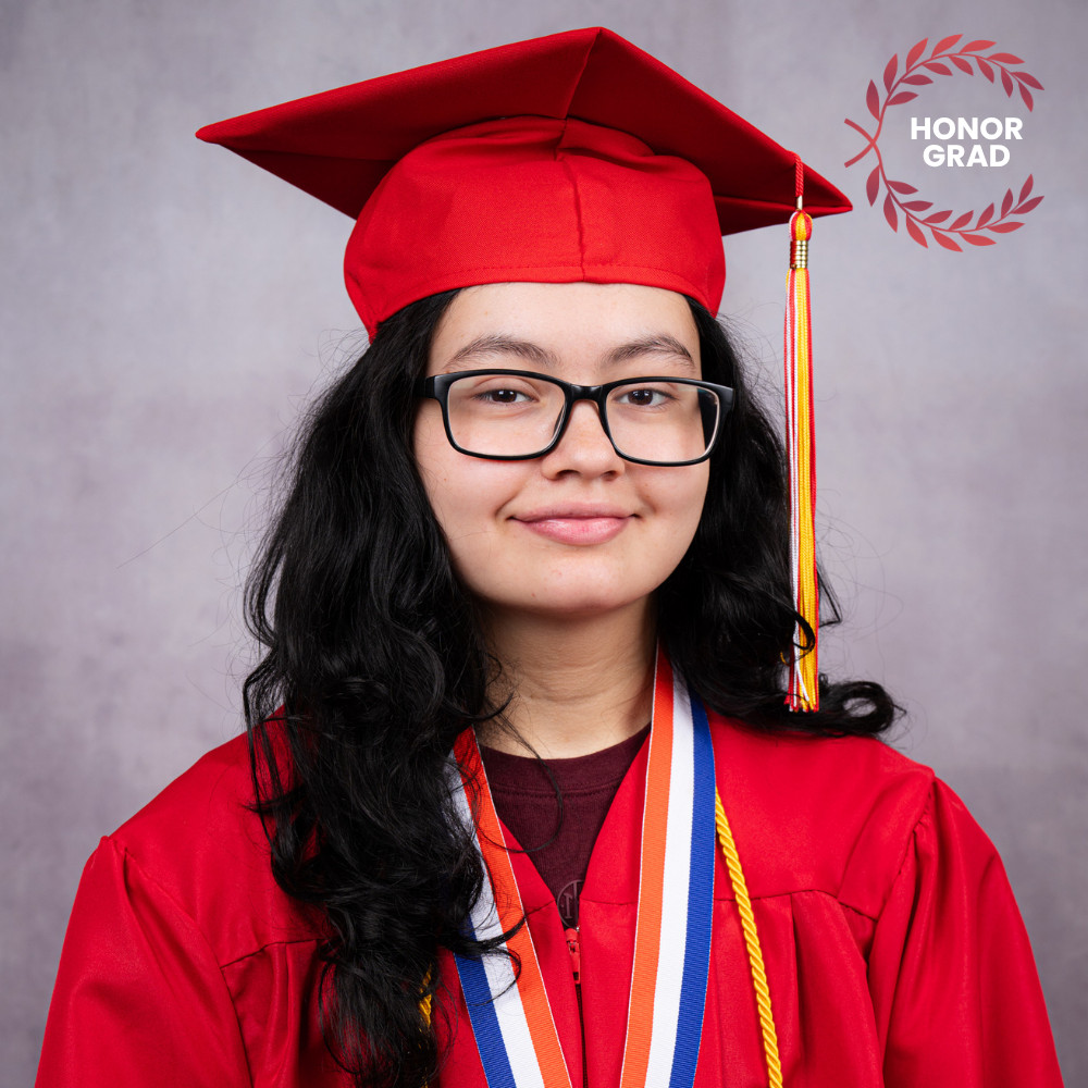 Hannah Alford wearing a red cap and gown.