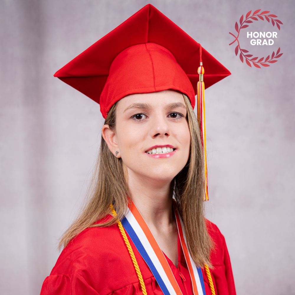 Ellen Allala wearing a red cap and gown.