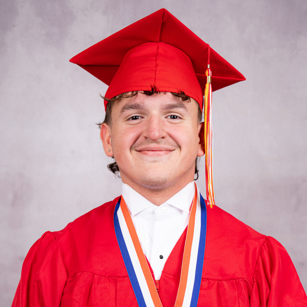Eduardo Aviles Cortes wearing a red cap and gown.