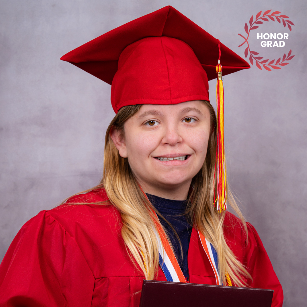 Lauren Beisbier wearing a red cap and gown.