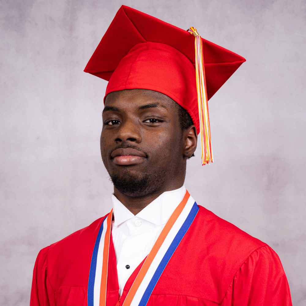 Edward Bell wearing a red cap and gown.