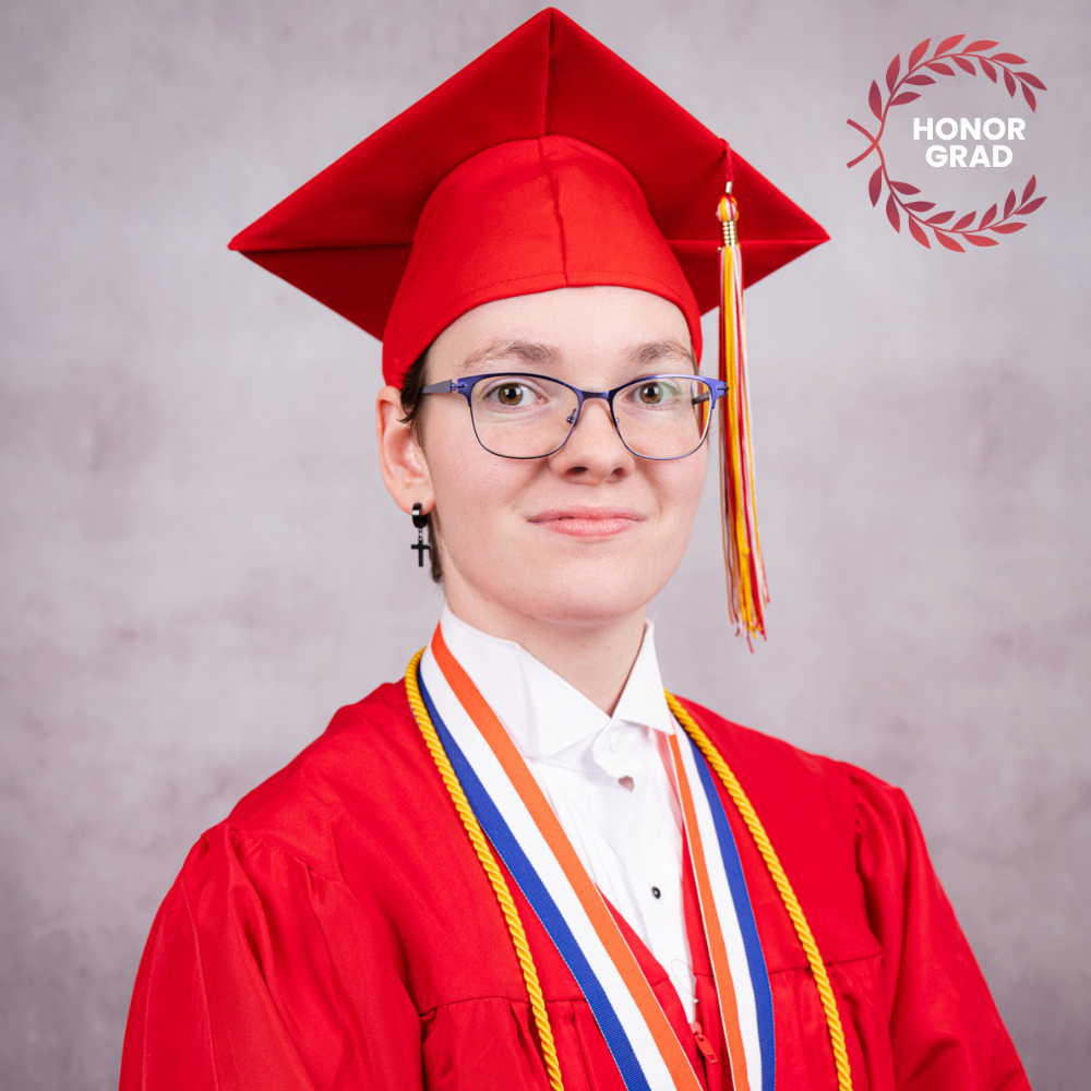 Nikki Cicio wearing a red cap and gown.