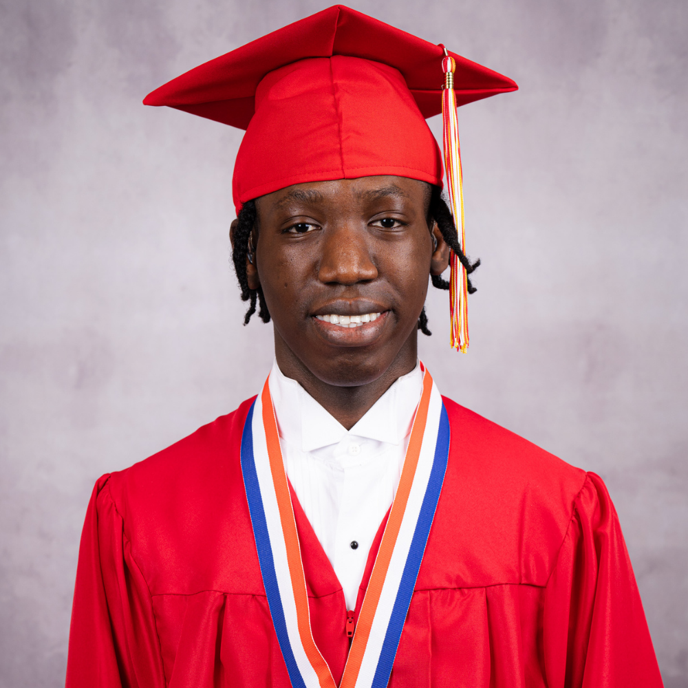 Hakeem Cius wearing a red cap and gown.