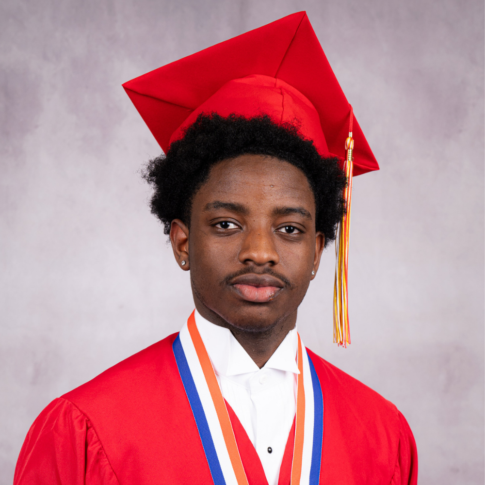 Mansky Collin wearing a red cap and gown.