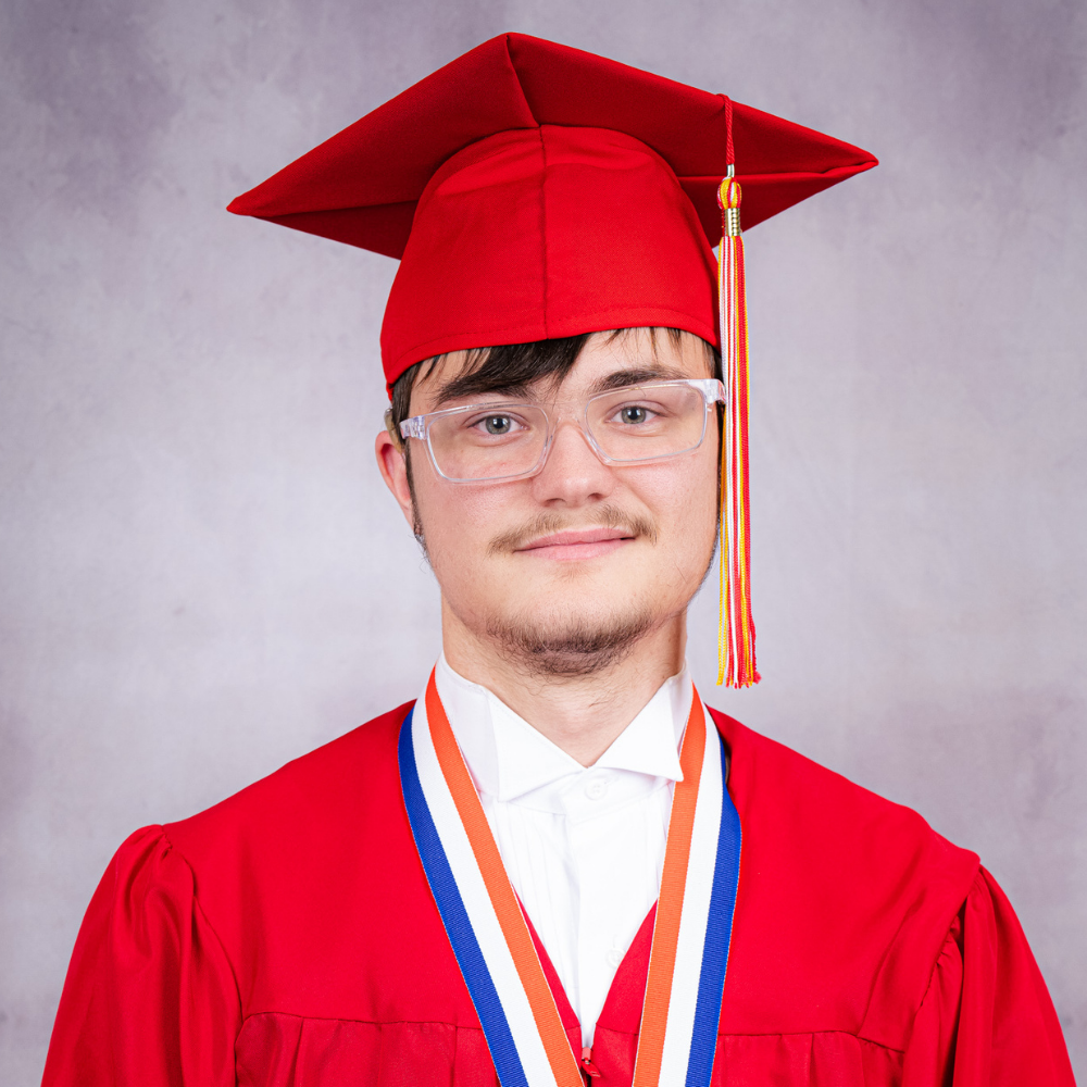 Chase Cooke wearing a red cap and gown.