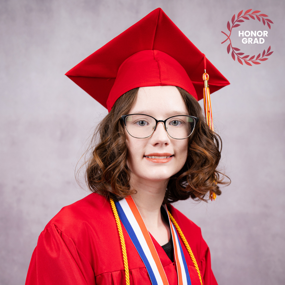 Isabella Cooper wearing a red cap and gown.