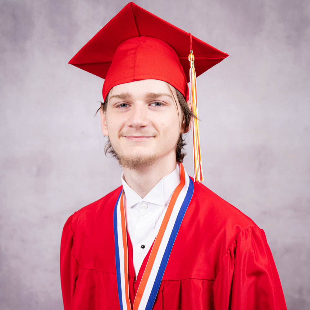 Bryce De Los Santos wearing a red cap and gown.