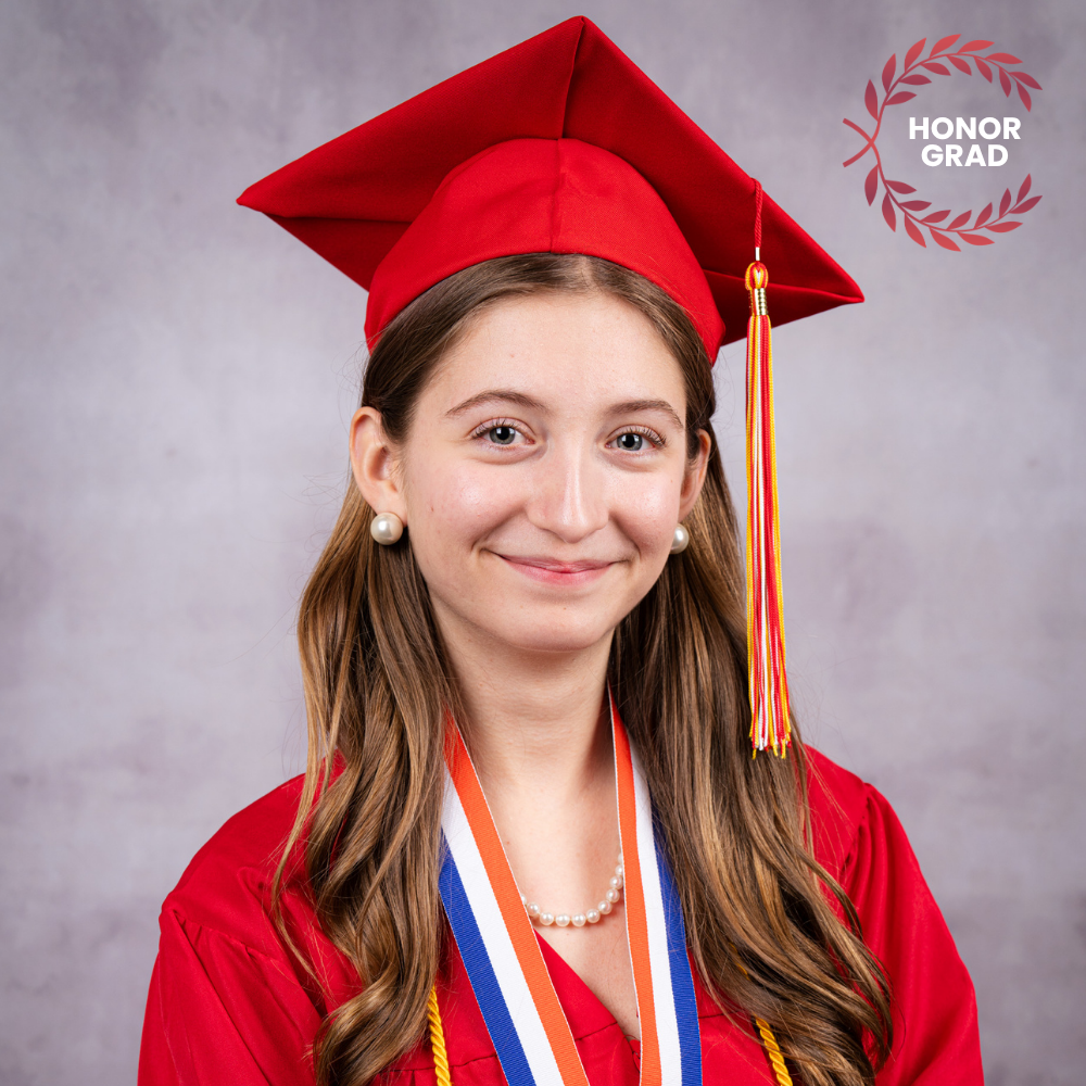 Brenna Freeman wearing a red cap and gown.