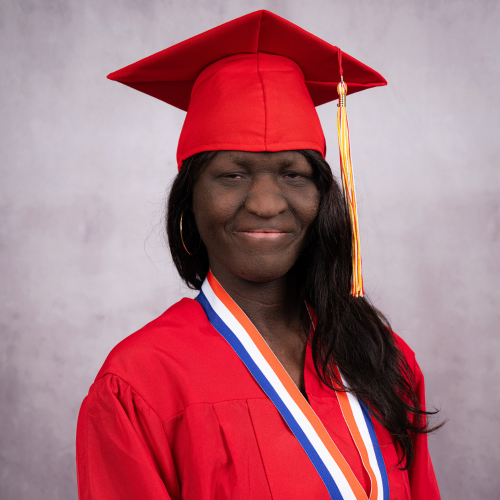 Diamond Durham wearing a red cap and gown.