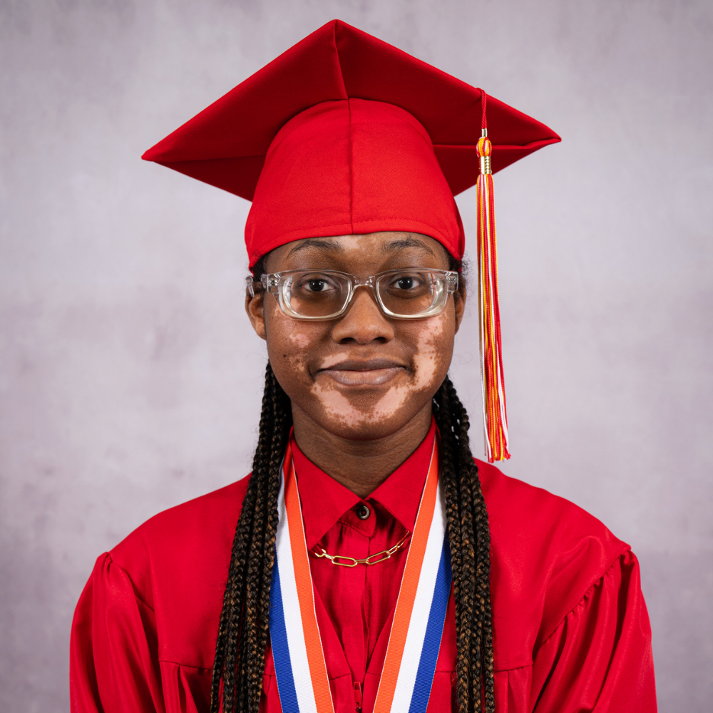 Nebreya Garland  wearing a red cap and gown.