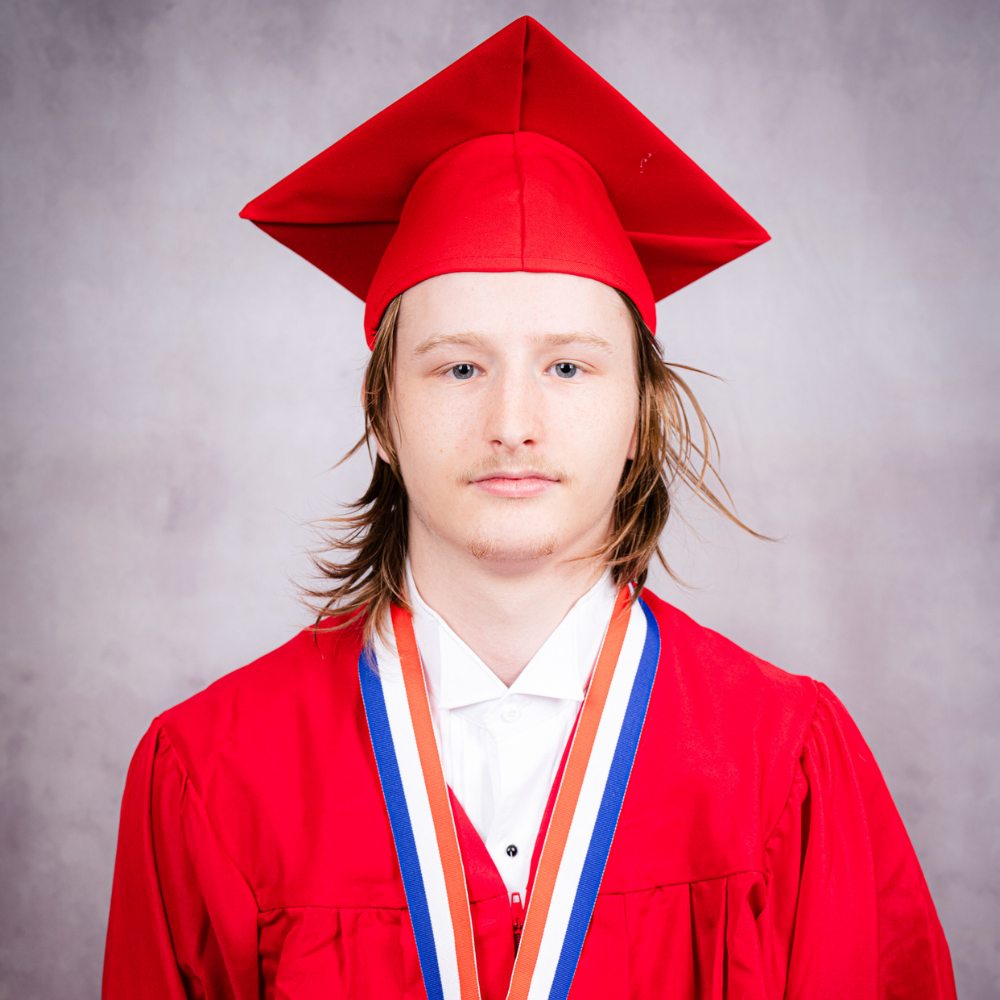 Lucius Hembree  wearing a red cap and gown.
