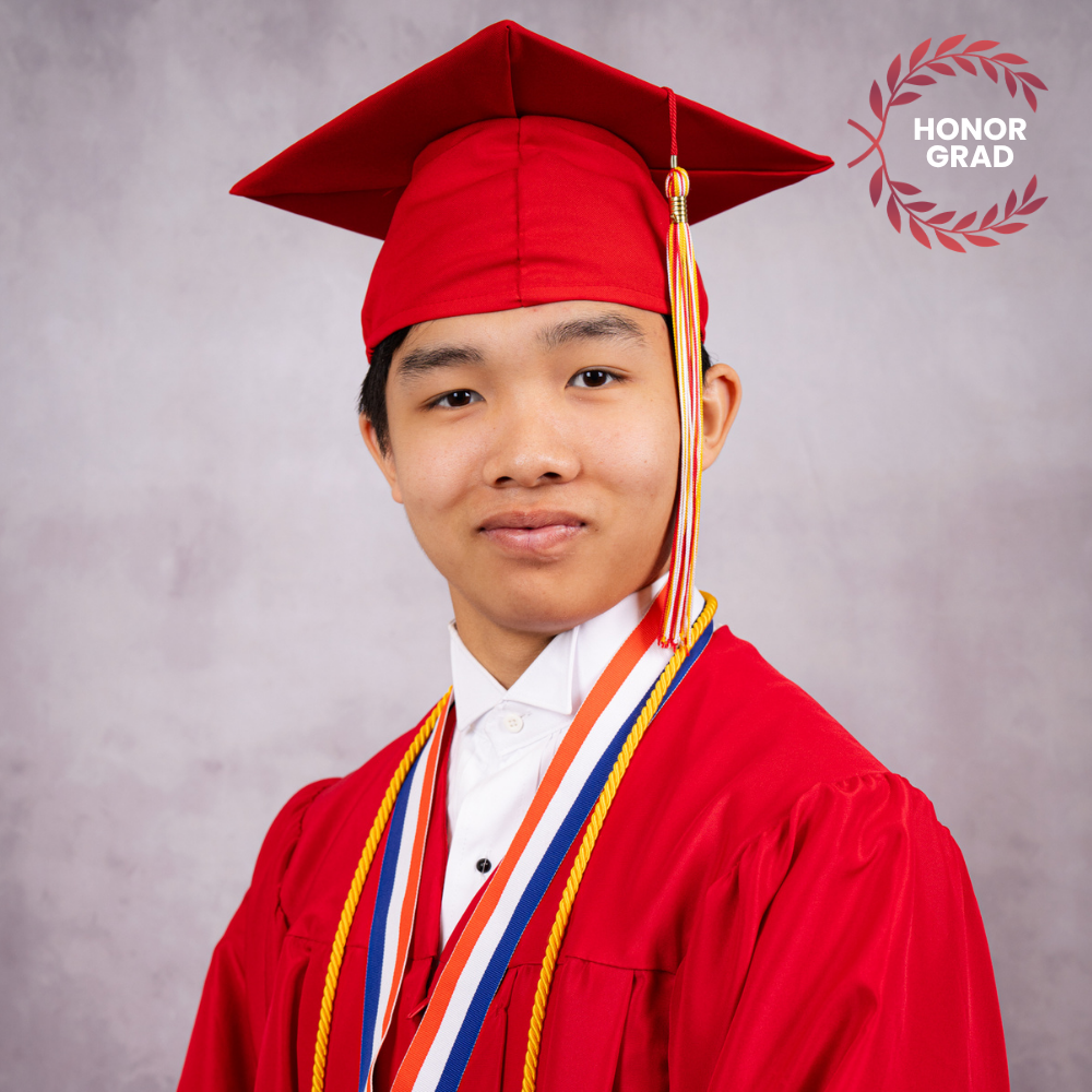 Kai Huot wearing a red cap and gown.