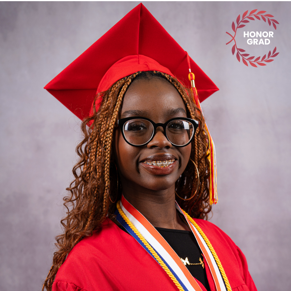 Megan Kyobe wearing a red cap and gown.
