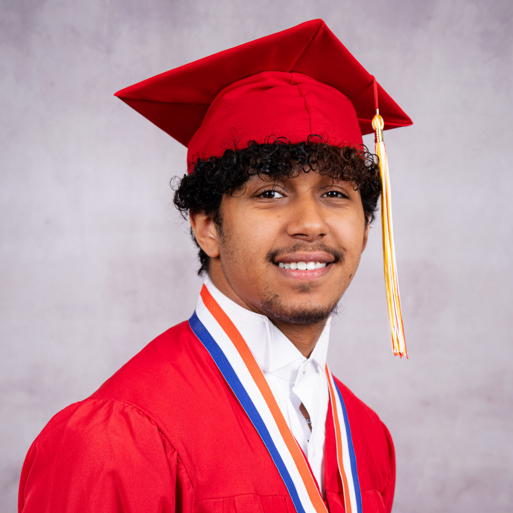 Robert Mccullough wearing a red cap and gown.
