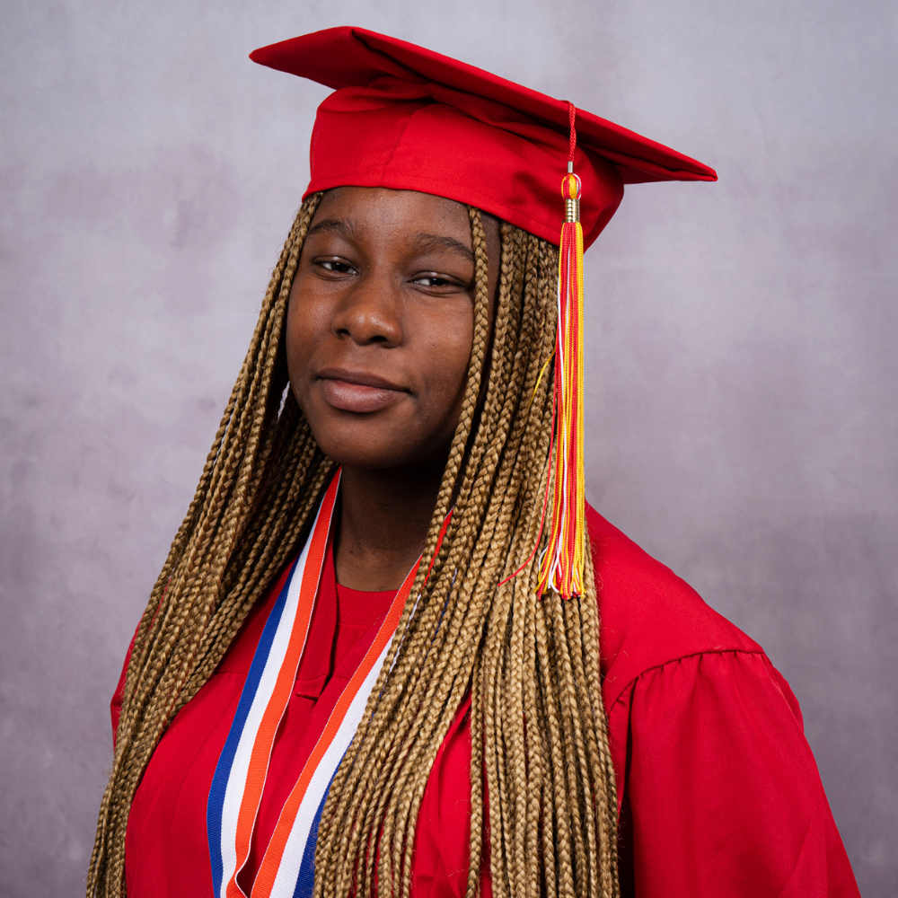 Marshanti Montgomery wearing a red cap and gown.