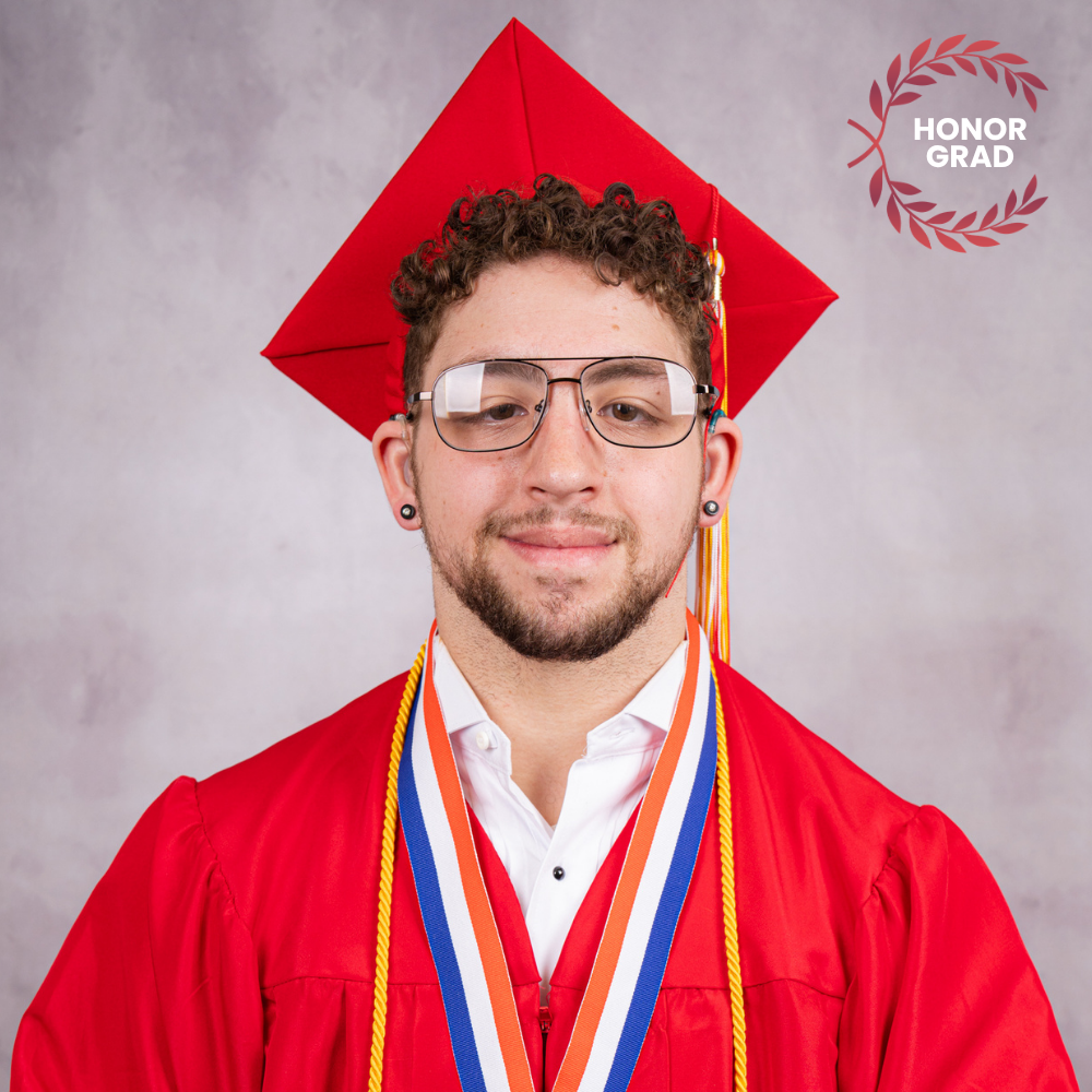 LaSean Nagle wearing a red cap and gown.