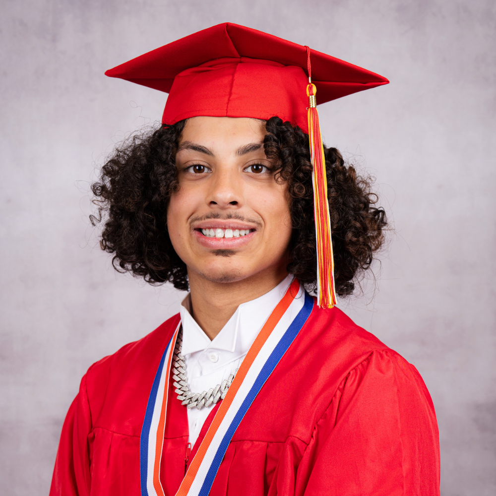Jayden Rosario-Crespo wearing a red cap and gown.