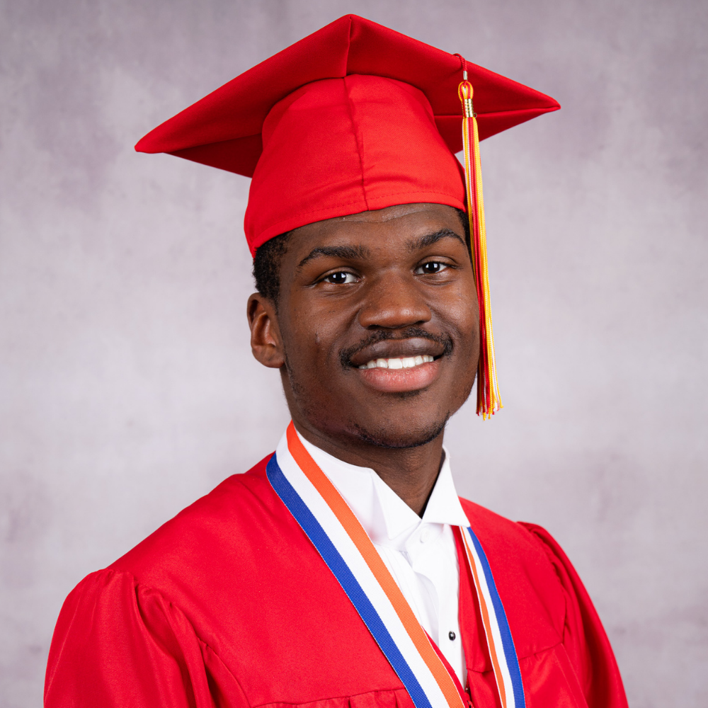 Ja'Morien Scott wearing a red cap and gown.